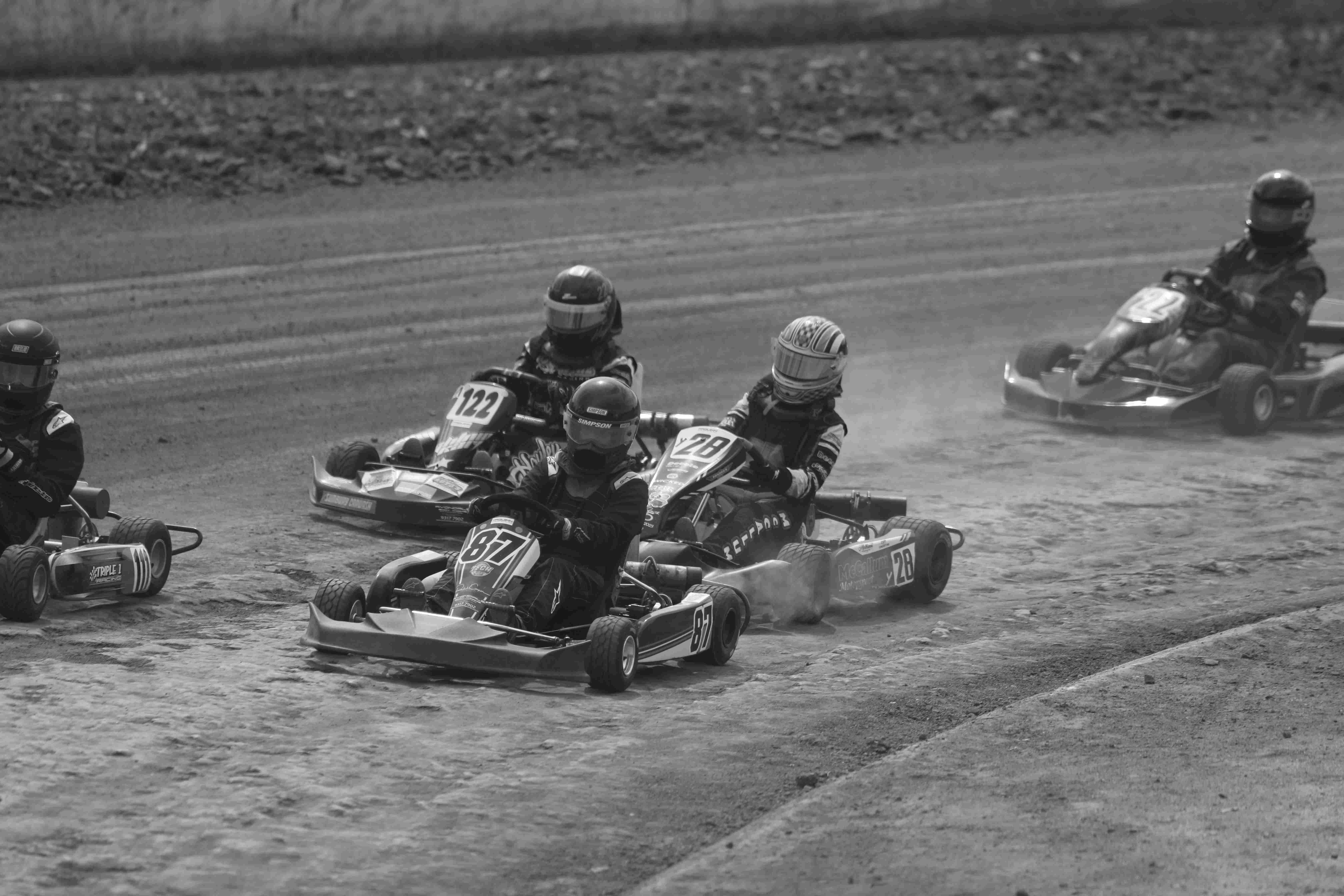 5 go karts on a track mid race