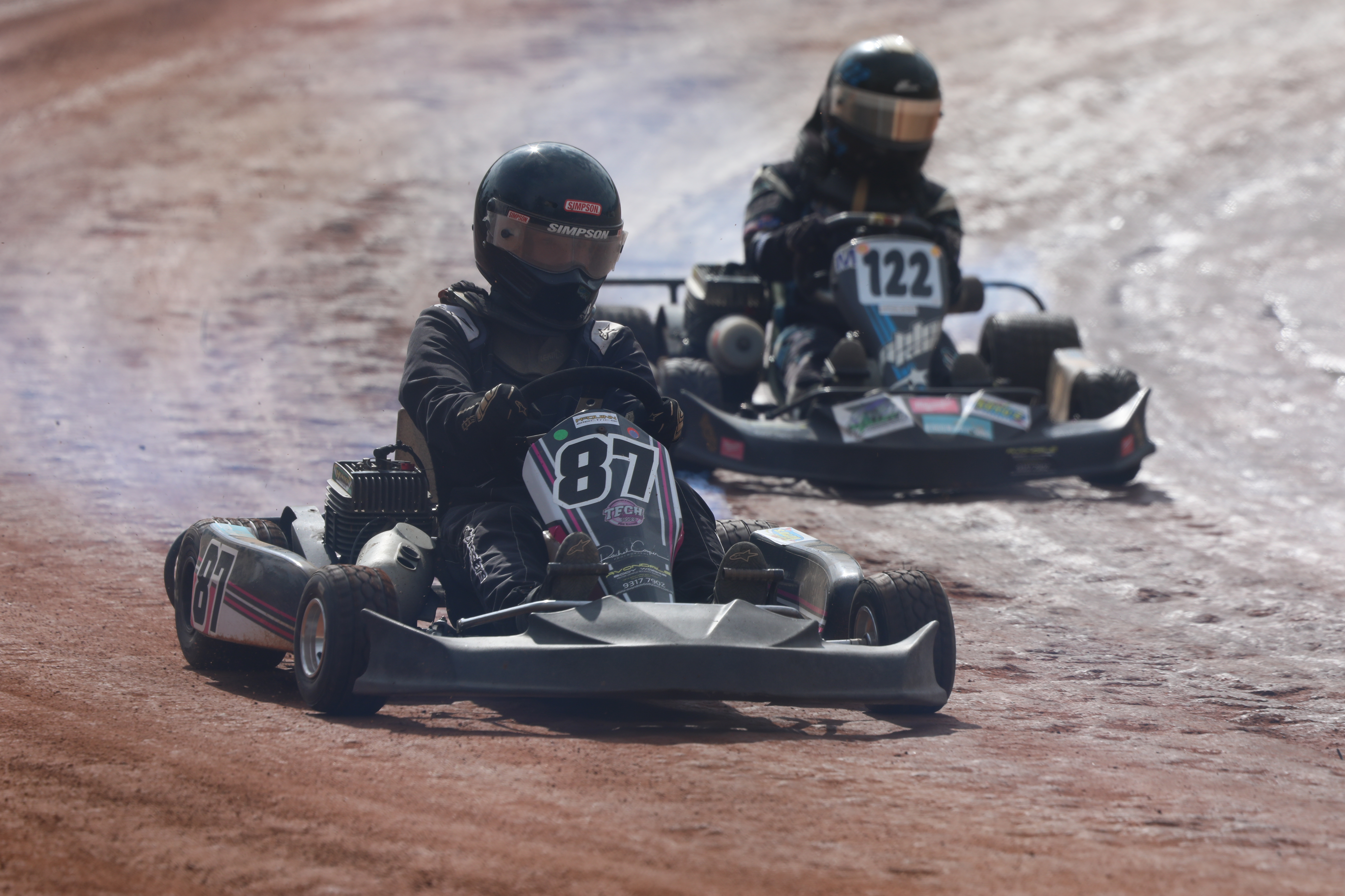 Two go karts on a track mid race