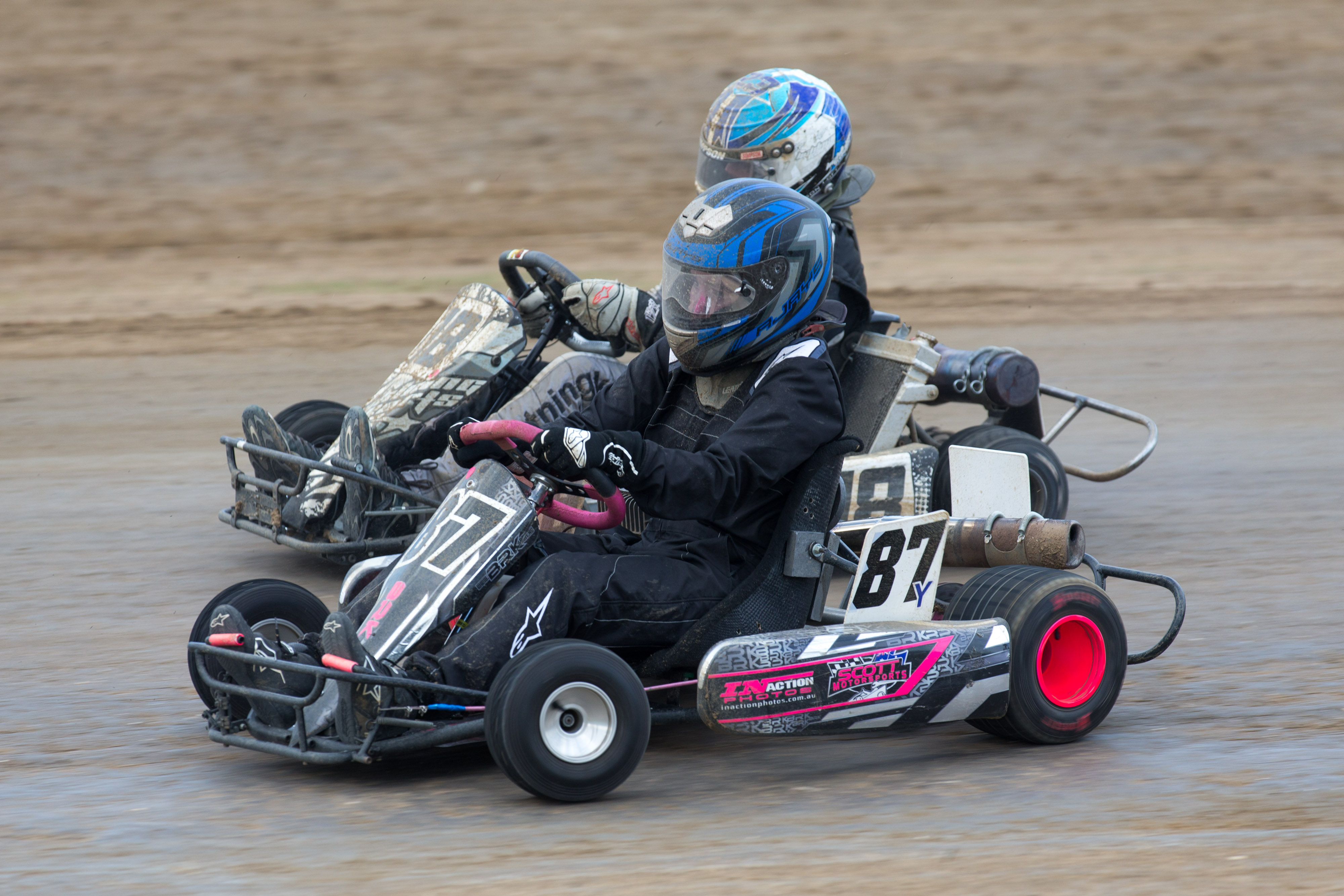 Two go karts racing on a track